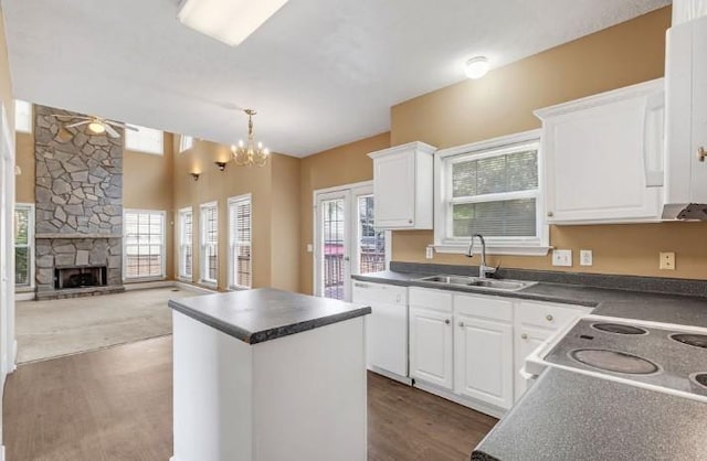 kitchen with a kitchen island, sink, white cabinets, hanging light fixtures, and white dishwasher