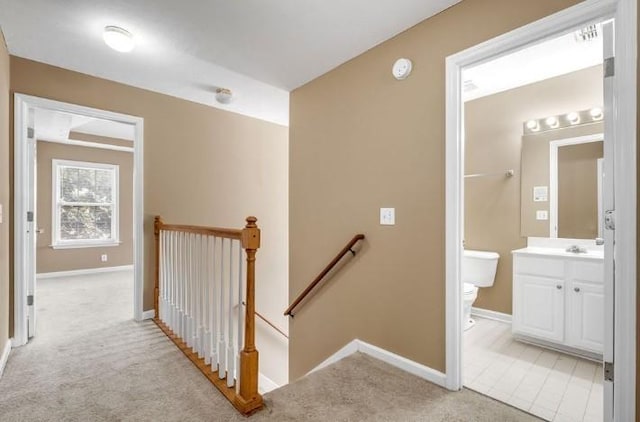 stairway with carpet flooring and sink