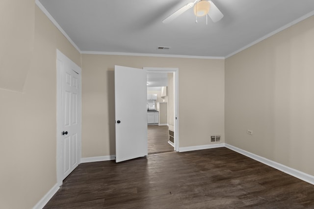 spare room with crown molding, dark hardwood / wood-style floors, and ceiling fan