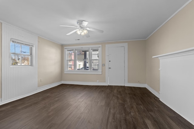 spare room featuring dark hardwood / wood-style flooring, ornamental molding, and ceiling fan