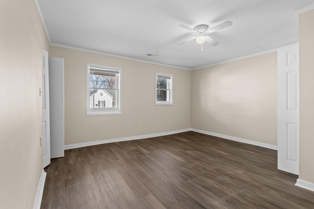 spare room with crown molding, dark wood-type flooring, and ceiling fan