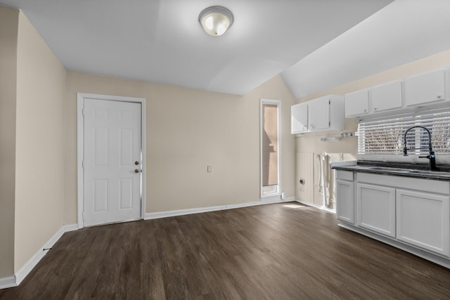 kitchen featuring lofted ceiling, dark hardwood / wood-style floors, sink, and white cabinets