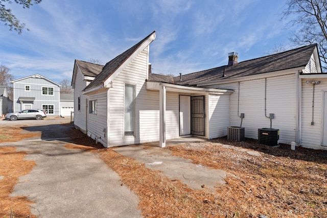 rear view of property featuring central air condition unit