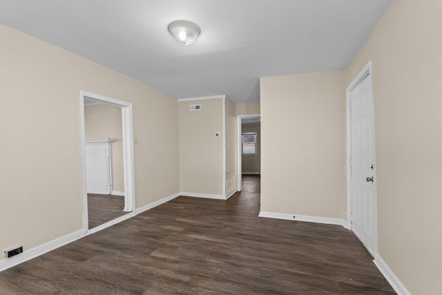 unfurnished room featuring dark hardwood / wood-style flooring