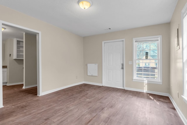 spare room with wood-type flooring