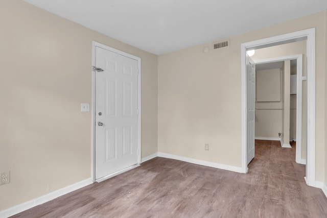 spare room featuring light hardwood / wood-style floors