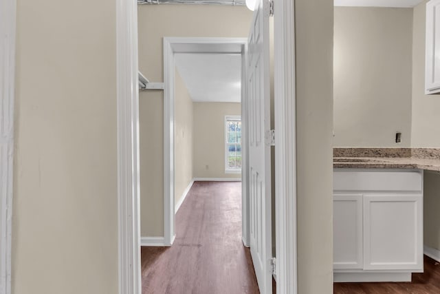 corridor with dark hardwood / wood-style flooring