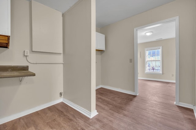 laundry room with light wood-type flooring