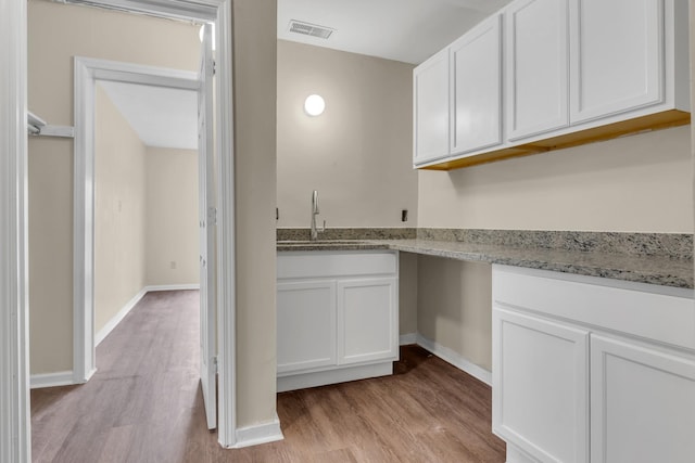 laundry area with sink and light wood-type flooring