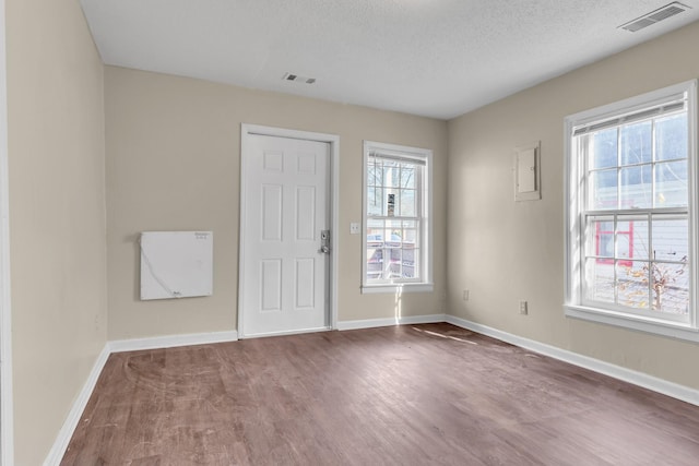 spare room with wood-type flooring and a textured ceiling