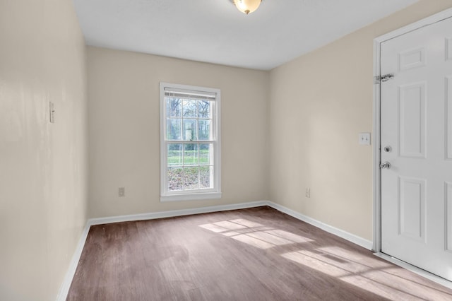 unfurnished room with light wood-type flooring