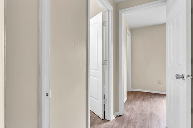 corridor with light wood-type flooring