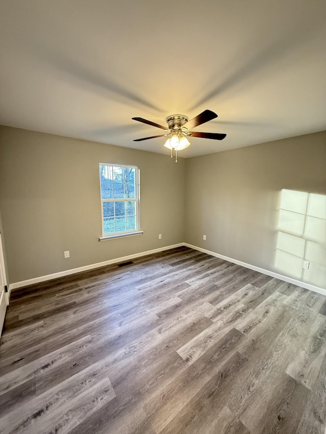 spare room featuring hardwood / wood-style flooring and ceiling fan