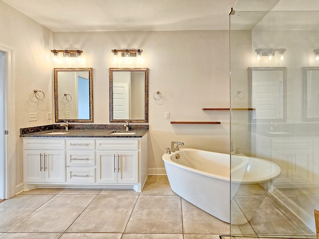 bathroom with vanity, a tub to relax in, and tile patterned floors