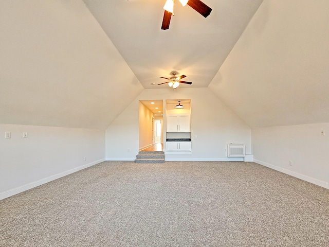 additional living space featuring lofted ceiling, ceiling fan, and carpet flooring