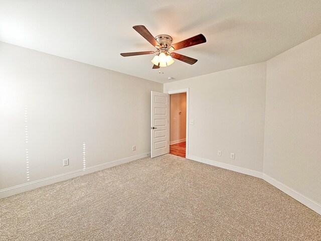 unfurnished room with ceiling fan and carpet flooring