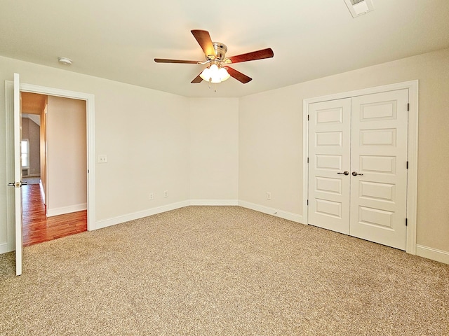 unfurnished bedroom featuring ceiling fan, carpet flooring, and a closet