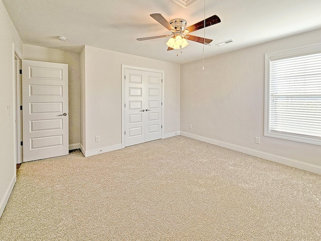 unfurnished bedroom featuring carpet flooring, ceiling fan, and a closet