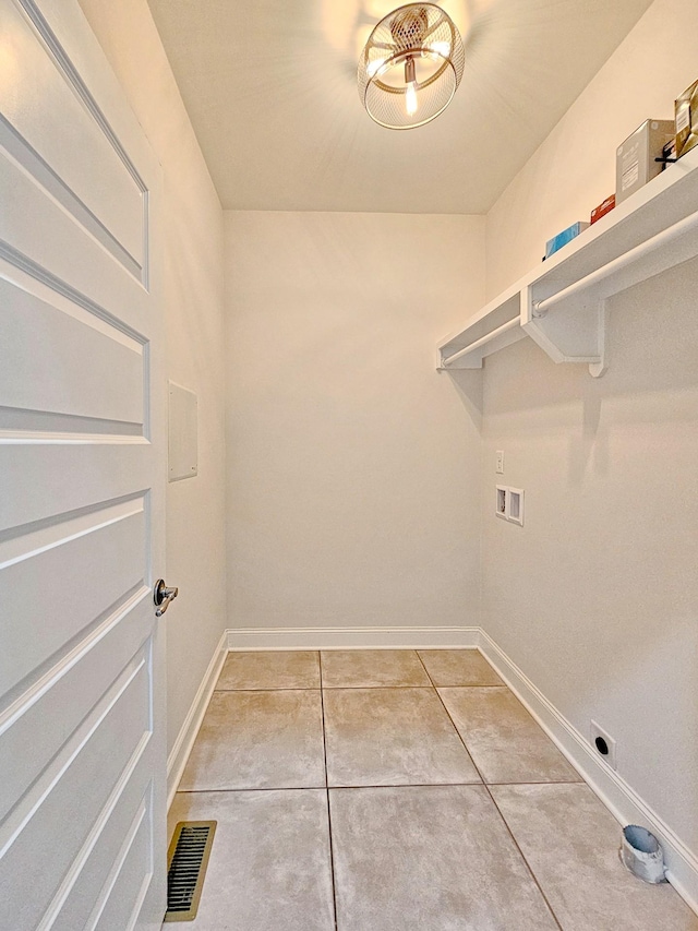 laundry area featuring washer hookup and tile patterned flooring