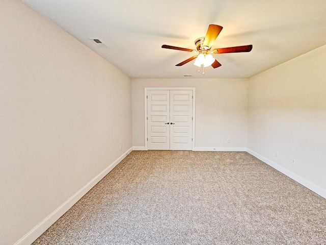 unfurnished bedroom with carpet, ceiling fan, and a closet