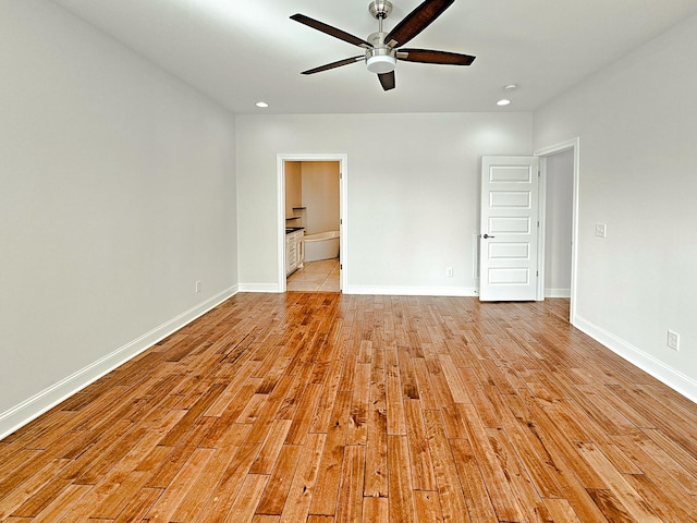 spare room with light hardwood / wood-style flooring and ceiling fan