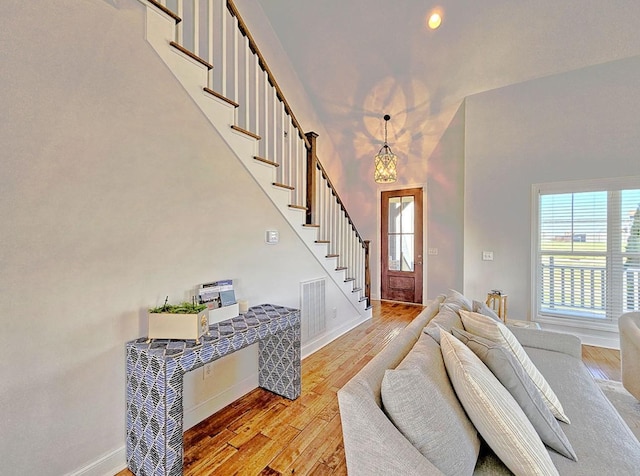 foyer entrance with light hardwood / wood-style floors and a high ceiling