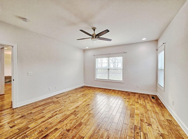 unfurnished room with a textured ceiling, light hardwood / wood-style flooring, and ceiling fan