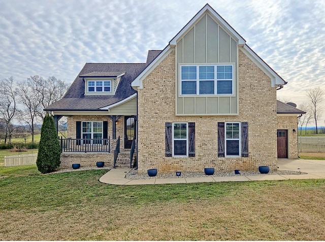 view of front of property with a porch and a front yard