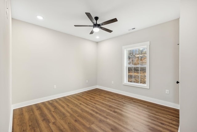 unfurnished room with ceiling fan and dark hardwood / wood-style flooring