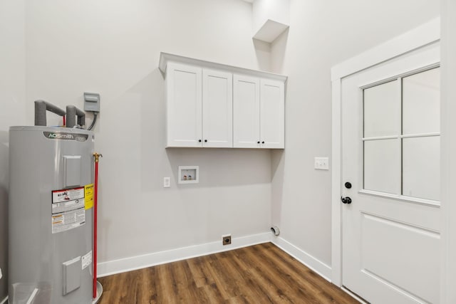 washroom featuring dark hardwood / wood-style flooring, cabinets, washer hookup, electric water heater, and hookup for an electric dryer