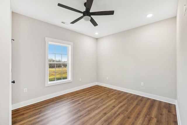 empty room featuring dark wood-type flooring and ceiling fan