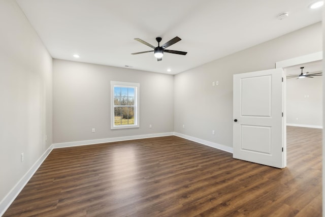 unfurnished room featuring dark wood-type flooring and ceiling fan