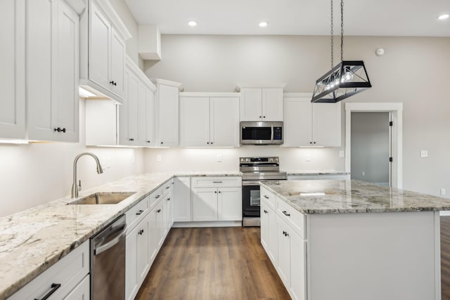 kitchen featuring pendant lighting, sink, stainless steel appliances, and white cabinets