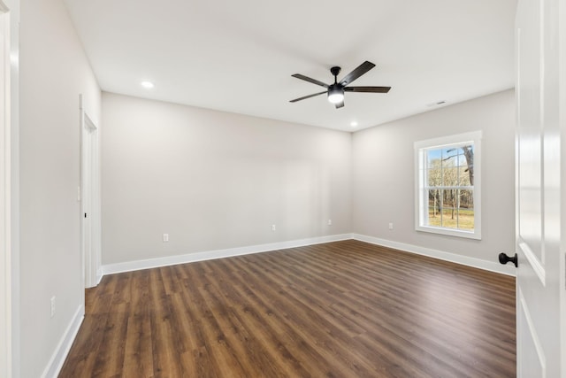 empty room featuring ceiling fan and dark hardwood / wood-style floors