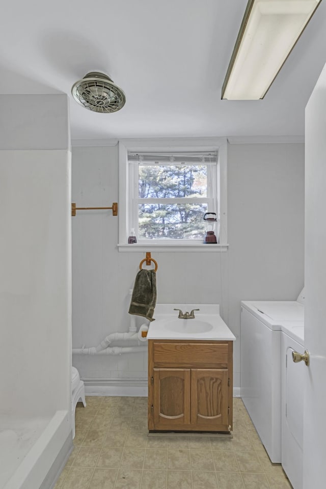 bathroom featuring vanity and washer and dryer