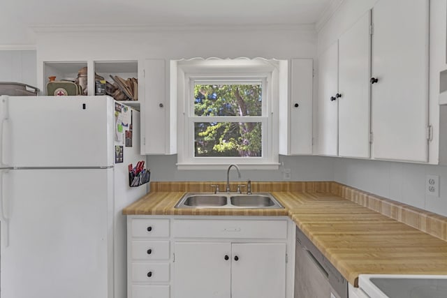 kitchen featuring sink, white cabinets, white fridge, stainless steel dishwasher, and crown molding