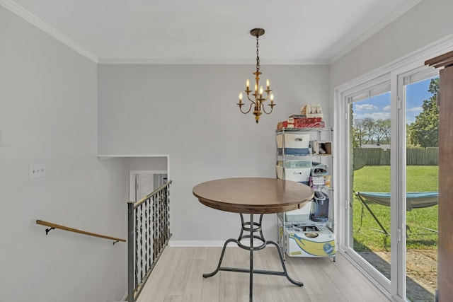 dining area with an inviting chandelier, crown molding, and light hardwood / wood-style flooring