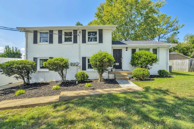 tri-level home with a front lawn