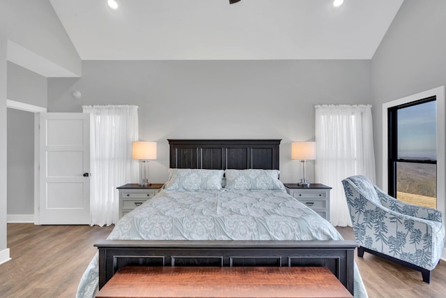 bedroom featuring lofted ceiling and light wood-type flooring