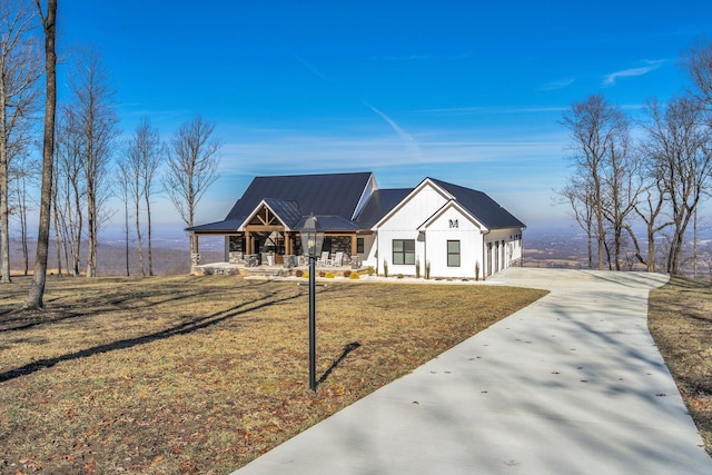 modern farmhouse with a front yard and a porch