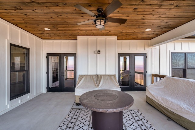 bedroom featuring light hardwood / wood-style flooring, access to outside, wooden ceiling, and french doors