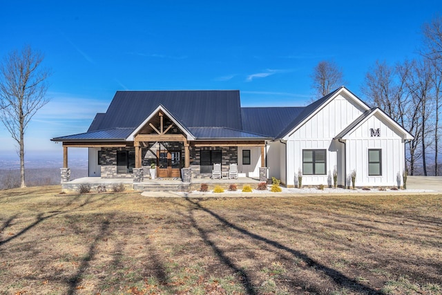 modern farmhouse style home featuring a front yard and covered porch