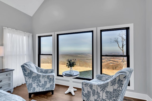 sitting room with vaulted ceiling and dark hardwood / wood-style flooring