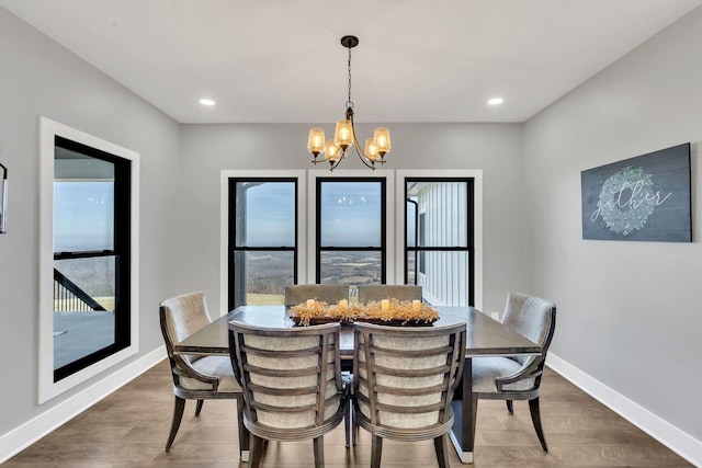 dining room featuring dark hardwood / wood-style flooring and a chandelier