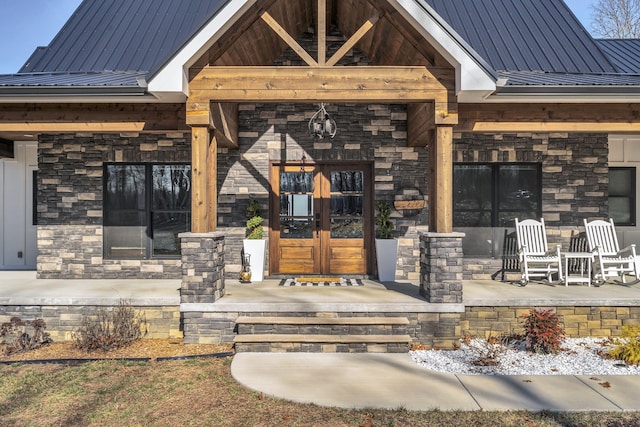 entrance to property featuring french doors and covered porch