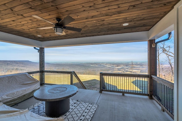 deck featuring ceiling fan and an outdoor fire pit