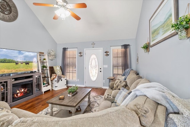 living room featuring dark wood-type flooring, high vaulted ceiling, and ceiling fan