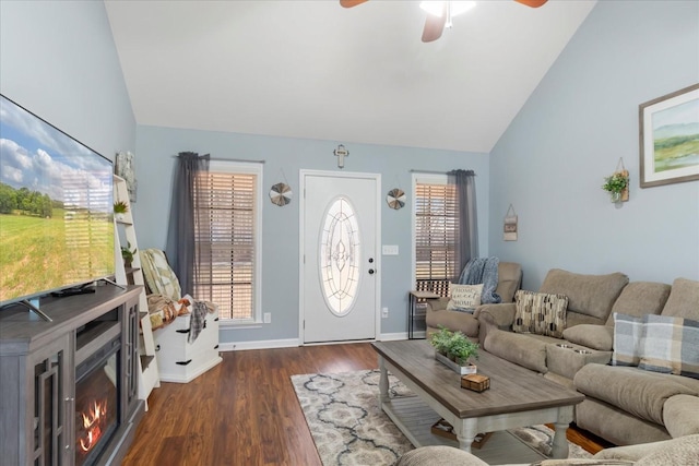 living room with dark wood-type flooring, a healthy amount of sunlight, lofted ceiling, and ceiling fan