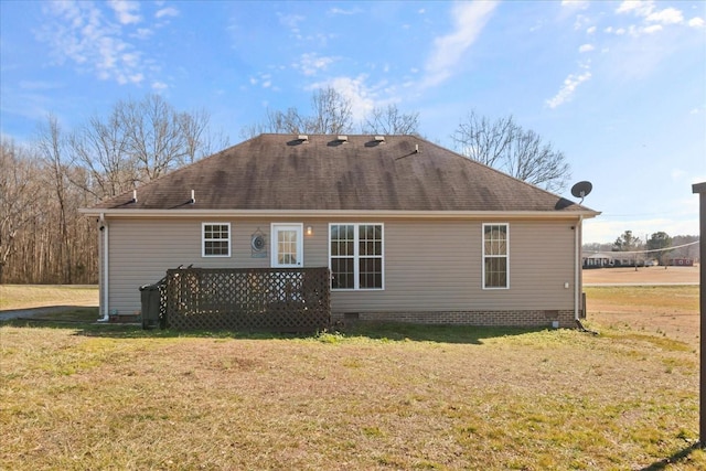 rear view of property featuring a deck and a lawn