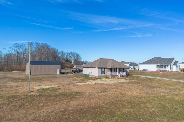 view of yard featuring a storage shed and covered porch